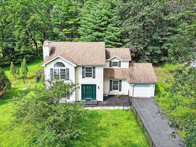 113 Dennis Ct, East Stroudsburg, PA 18301 - traditional home featuring a garage, asphalt driveway, a chimney, and a front yard