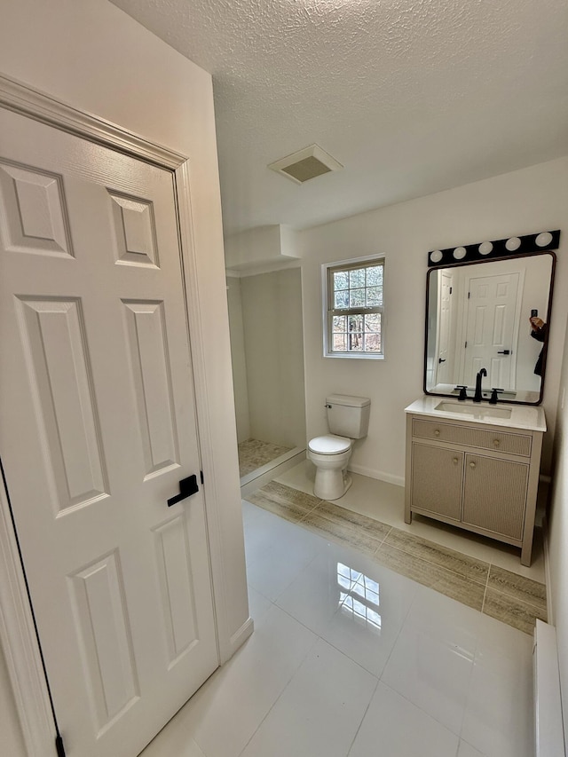 bathroom with visible vents, toilet, a textured ceiling, vanity, and baseboards