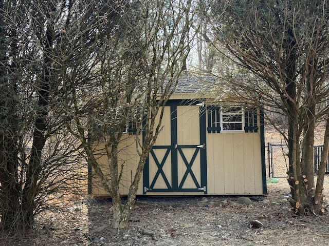 view of shed featuring fence