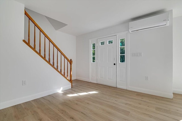 113 Dennis Ct, East Stroudsburg, PA 18301 - foyer entrance featuring a wall mounted AC, light wood finished floors, and stairway