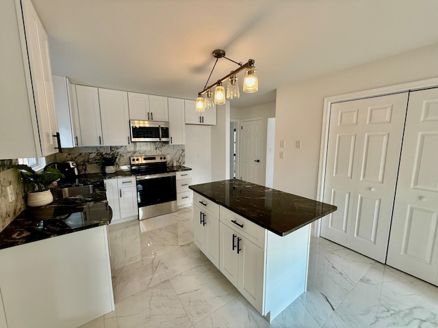 kitchen with tasteful backsplash, white cabinets, a kitchen island, marble finish floor, and stainless steel appliances