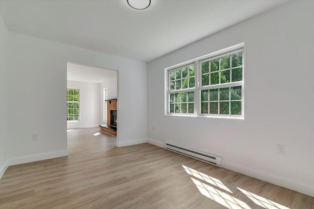 113 Dennis Ct, East Stroudsburg, PA 18301 - unfurnished living room with baseboard heating, healthy amount of natural light, light wood-style flooring, and a fireplace