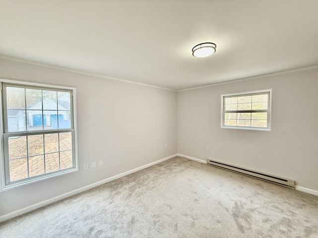 unfurnished room with a baseboard heating unit, carpet, crown molding, and plenty of natural light