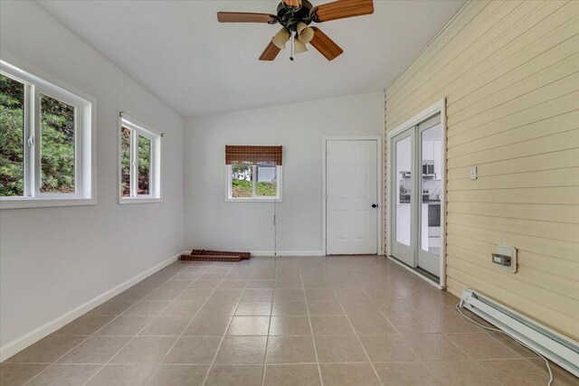 113 Dennis Ct, East Stroudsburg, PA 18301 - tiled empty room featuring baseboard heating, a ceiling fan, wooden walls, and vaulted ceiling