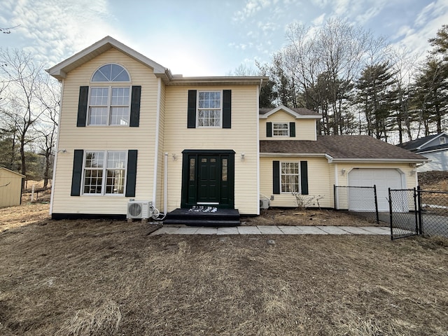 view of front facade featuring ac unit, an attached garage, fence, and a gate