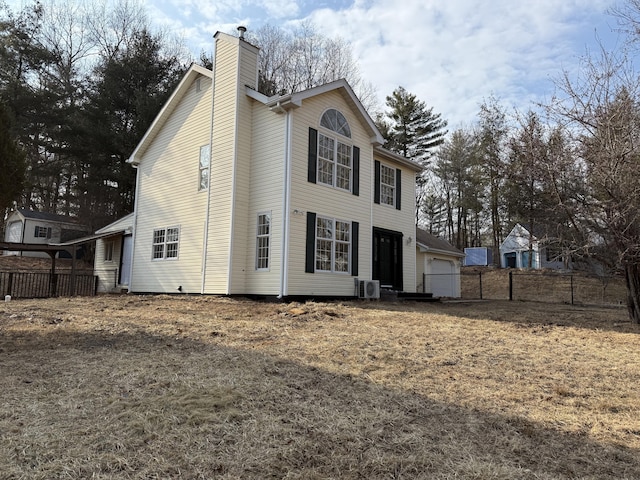 exterior space with fence and a chimney