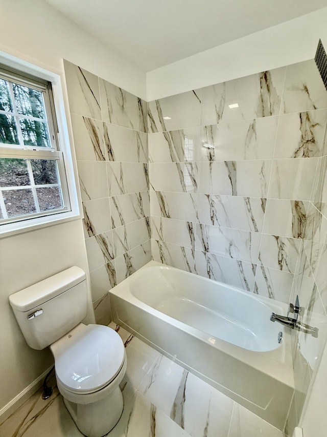 bathroom featuring marble finish floor, baseboards, and toilet