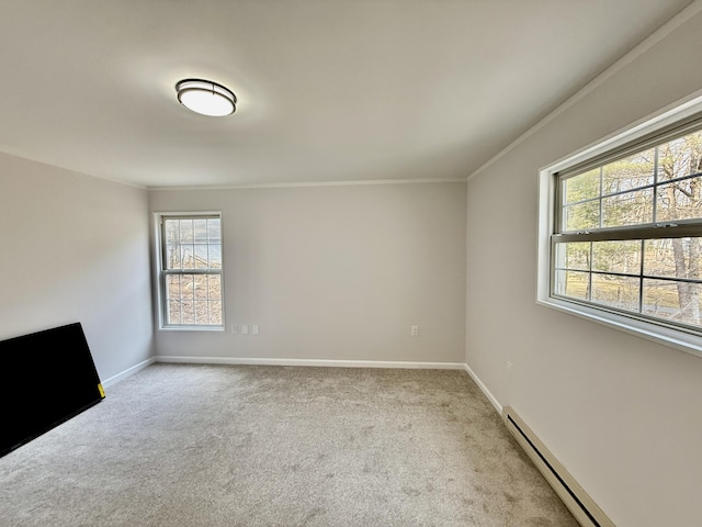 empty room with ornamental molding, baseboards, light carpet, and baseboard heating