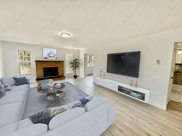 living room featuring a fireplace with raised hearth and wood finished floors