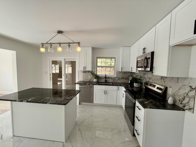 kitchen with stainless steel appliances, marble finish floor, white cabinets, and a sink