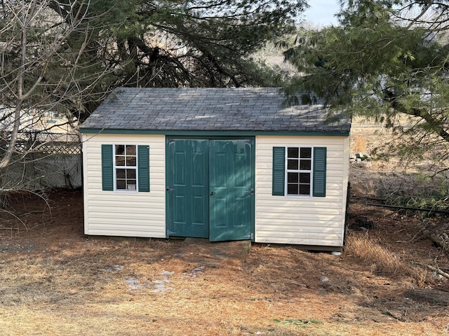 view of shed with fence