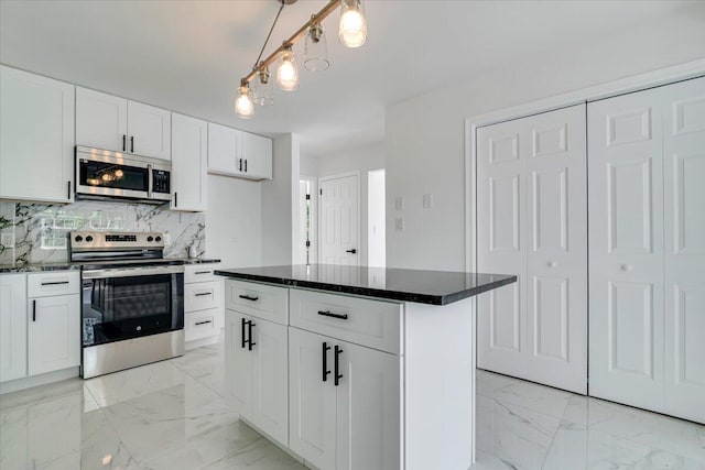 113 Dennis Ct, East Stroudsburg, PA 18301 - kitchen with stainless steel appliances, light marble finish floors, decorative backsplash, white cabinets, and decorative light fixtures