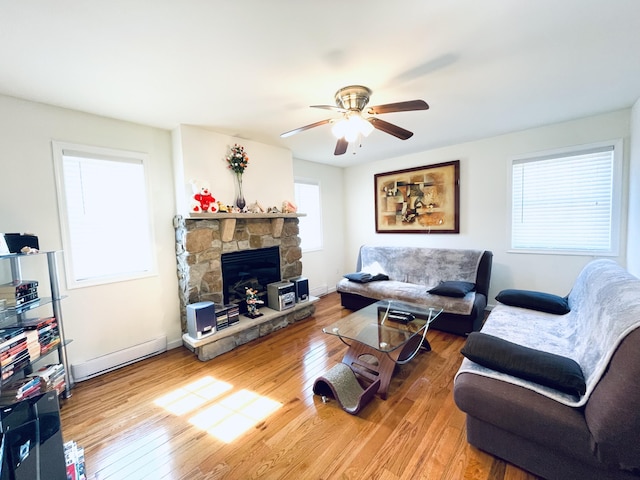 146 Hunter Ln, Albrightsville, PA 18210 - living area with healthy amount of natural light, wood finished floors, ceiling fan, and a stone fireplace