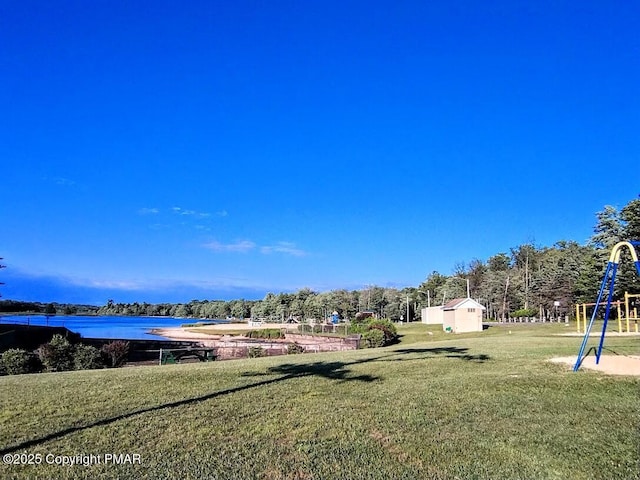 view of yard featuring a playground and a water view