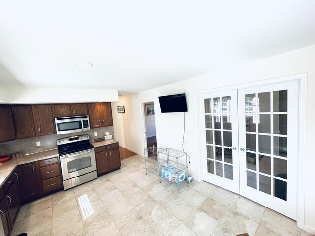 living room with ceiling fan, high vaulted ceiling, and light hardwood / wood-style flooring