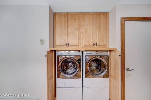 laundry area with cabinets and separate washer and dryer