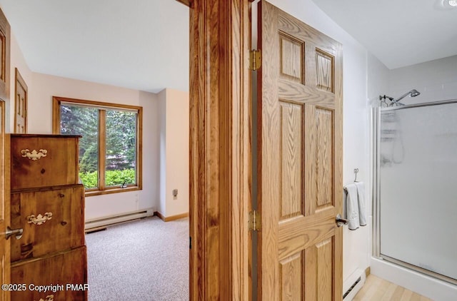 bathroom with an enclosed shower and a baseboard radiator