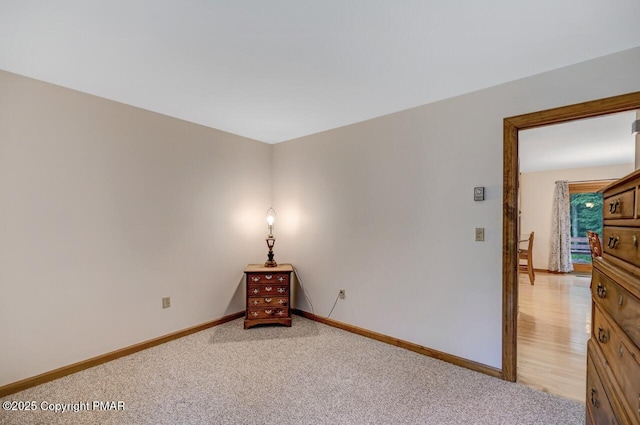 unfurnished room featuring light carpet