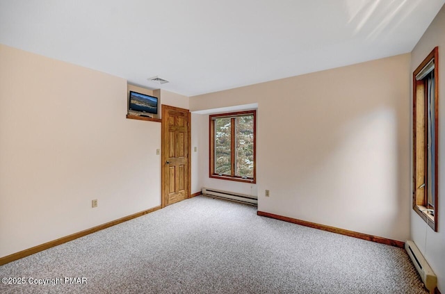 carpeted spare room featuring a baseboard radiator