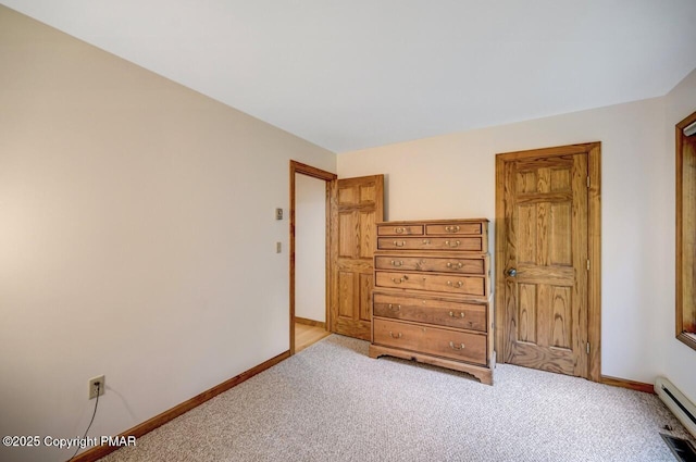 bedroom with a baseboard radiator and light colored carpet