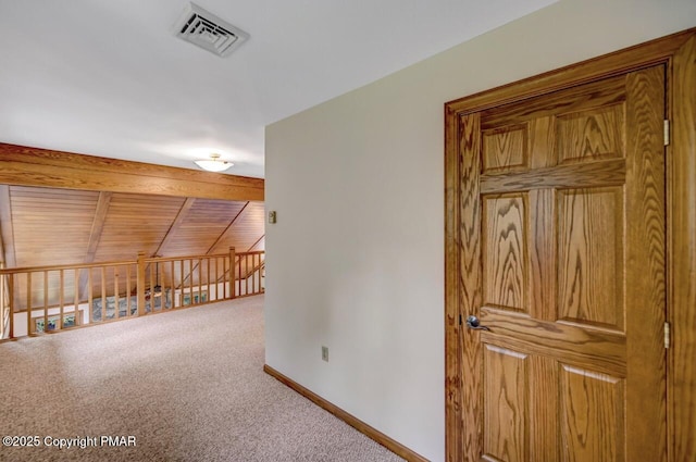 corridor featuring lofted ceiling with beams, carpet, and wooden ceiling