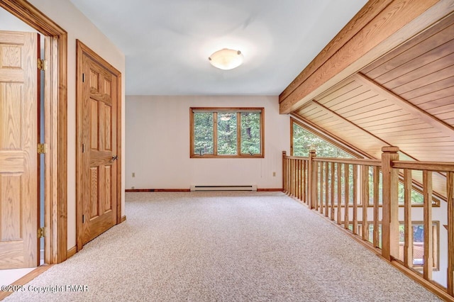 additional living space featuring lofted ceiling with beams, carpet, and a baseboard heating unit