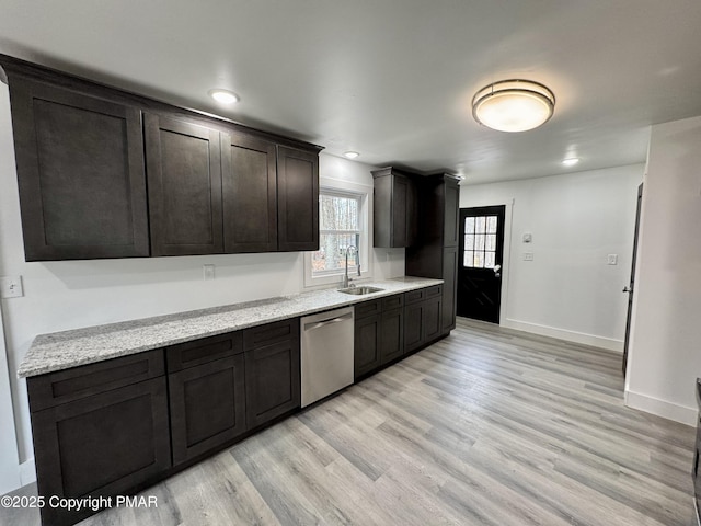 kitchen with baseboards, stainless steel dishwasher, dark brown cabinets, light wood-style floors, and a sink