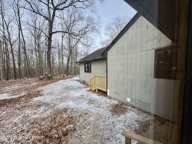 view of side of home featuring a shingled roof