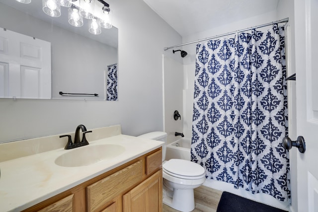 full bath featuring wood finished floors, vanity, toilet, and shower / tub combo