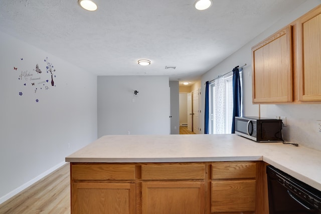 kitchen with black dishwasher, light countertops, light wood-style flooring, a peninsula, and baseboards