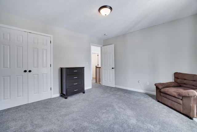 living area with baseboards and carpet flooring