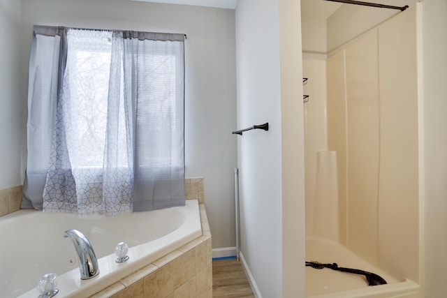 full bathroom with walk in shower, a garden tub, and baseboards