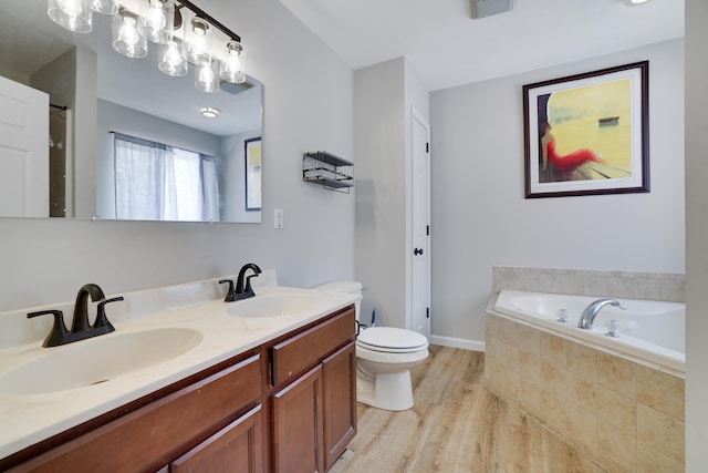 full bathroom featuring a garden tub, a sink, toilet, and wood finished floors