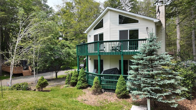 135 Tomhickon Trl, Pocono Lake, PA 18347 - view of front of house with a chimney and a wooden deck