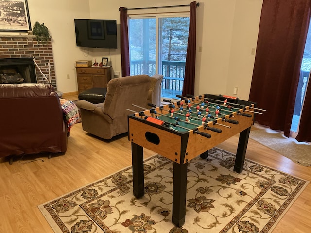 135 Tomhickon Trl, Pocono Lake, PA 18347 - playroom with light wood finished floors and a fireplace