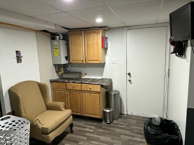 1010 Knollwood Dr, Tobyhanna, PA 18466 - finished basement featuring tankless water heater, dark wood-type flooring, and a paneled ceiling
