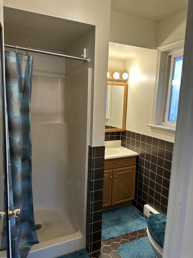 1010 Knollwood Dr, Tobyhanna, PA 18466 - bathroom with tile walls, a stall shower, tile patterned flooring, vanity, and a wainscoted wall