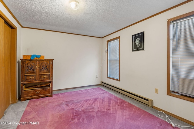 unfurnished bedroom featuring ornamental molding, light carpet, a textured ceiling, and baseboard heating