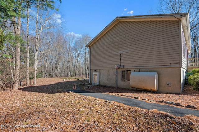 view of side of property featuring heating fuel