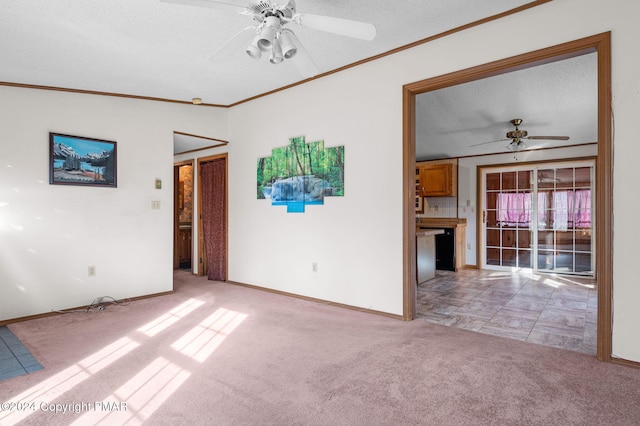 unfurnished room featuring ornamental molding, light carpet, ceiling fan, and baseboards