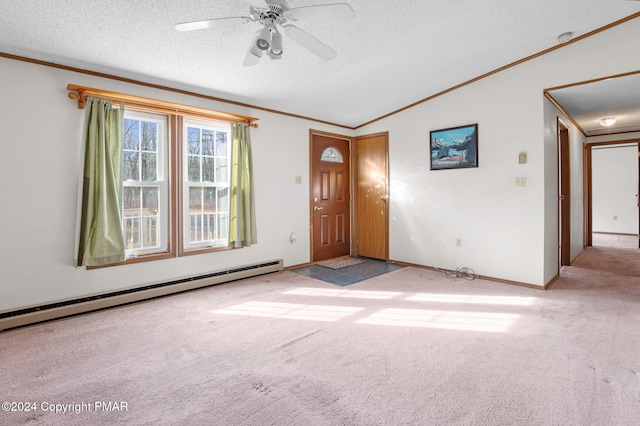 carpeted spare room featuring a baseboard radiator, lofted ceiling, ornamental molding, ceiling fan, and a textured ceiling