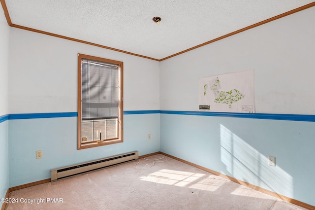 carpeted empty room with crown molding, baseboards, baseboard heating, and a textured ceiling