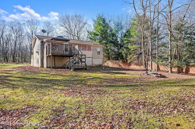 back of house with fence, stairway, a lawn, and a wooden deck