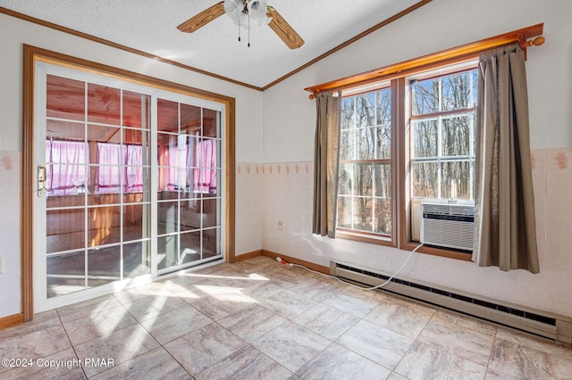 spare room with wainscoting, lofted ceiling, crown molding, a textured ceiling, and a baseboard heating unit