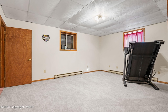 workout room featuring baseboard heating, a drop ceiling, carpet flooring, and baseboards