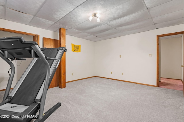 workout room with light carpet, baseboards, and a drop ceiling