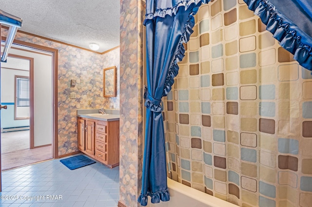 bathroom with a textured ceiling, a baseboard heating unit, vanity, ornamental molding, and tile patterned floors