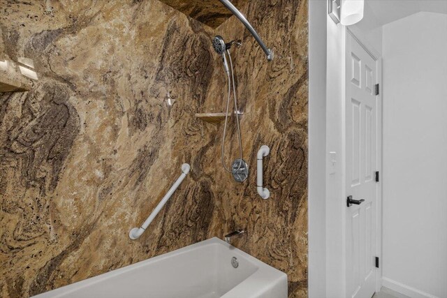 full bath featuring baseboards and bathtub / shower combination