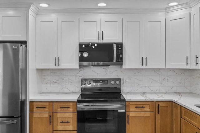 kitchen with backsplash, stainless steel appliances, white cabinets, and light stone counters