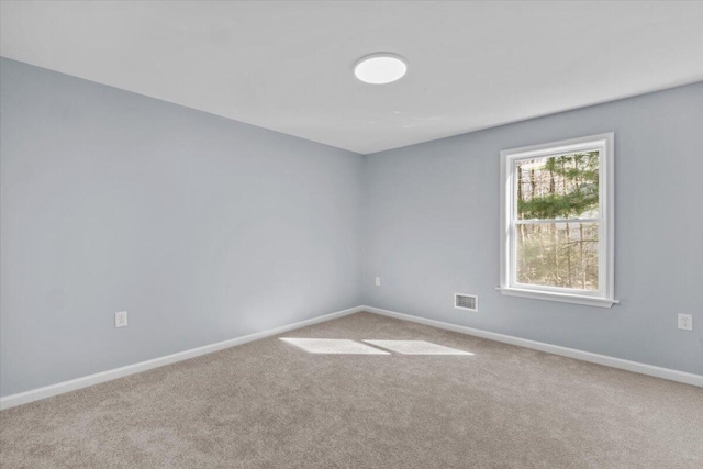 unfurnished room featuring carpet floors, baseboards, and visible vents